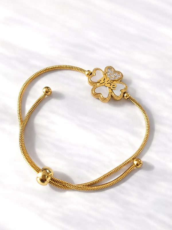 Pulseira ajustável em aço dourado com pendente de trevo de quatro folhas, inscrição Mãe e detalhes brilhantes